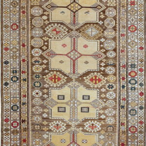 A long runner rug featuring tan and brown geometric medallions surrounded by detailed star borders.