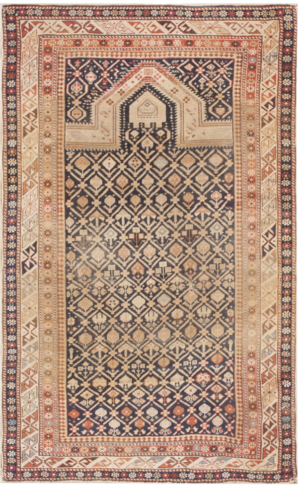 Geometric rug with a navy and tan diamond pattern field and a stepped arch design at the top.