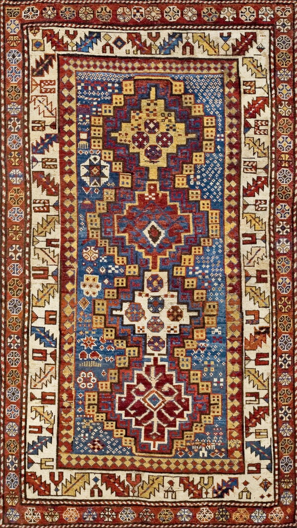 A geometric rug with a stepped medallion pattern in red, blue, cream, and yellow.