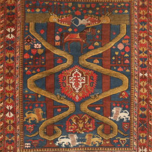 A dark blue and red patterned rug featuring stylized animals, trees, and large yellow serpentine designs.