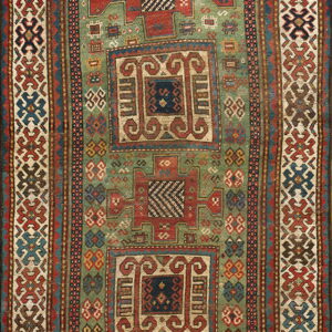 Geometric rug with a muted green field, complex red and blue tribal medallions, and wide patterned borders.