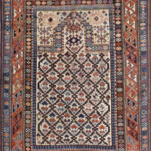 Densely patterned rug featuring multiple geometric borders, rust edges, and a cream field with navy lattice.