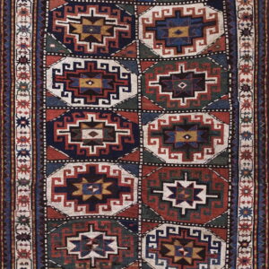 Geometric runner rug with repeating octagonal medallions in navy, rust, green, and cream.