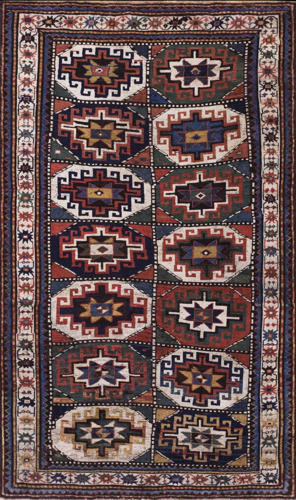 Geometric runner rug with repeating octagonal medallions in navy, rust, green, and cream.