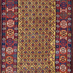Gold rug with a repeating diamond lattice pattern and bold red, blue, and white geometric medallion borders.