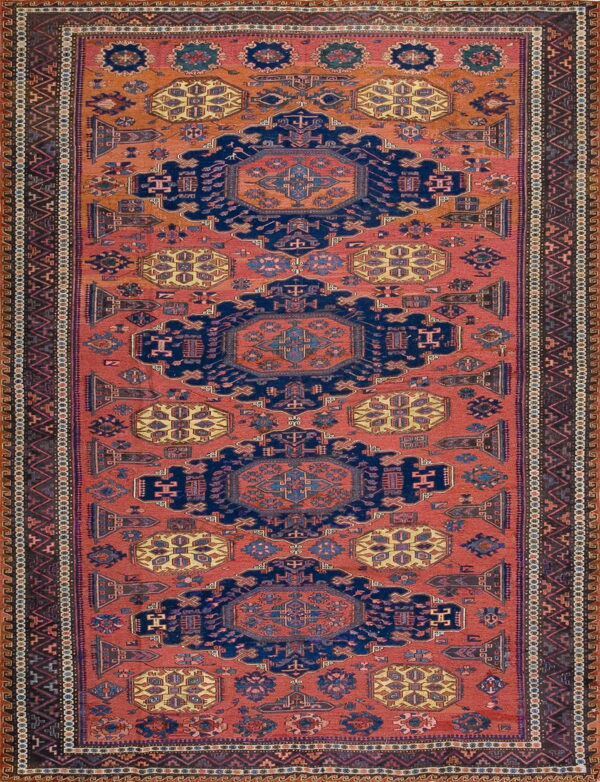 Rust and navy geometric runner rug with three large repeating central medallions and complex patterned borders.