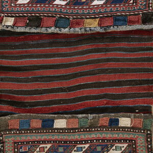 Geometric navy and cream panels frame a central red and black striped flatweave textile.