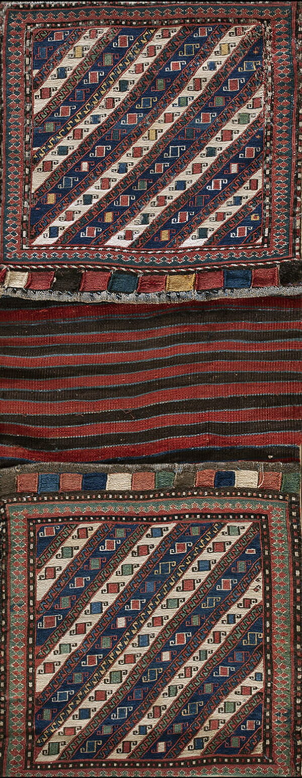 Geometric navy and cream panels frame a central red and black striped flatweave textile.