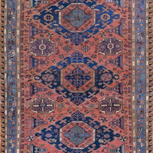 Geometric tribal rug in deep navy and reddish-orange with multiple intricate patterned borders.