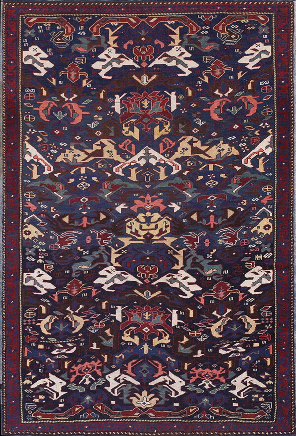 Navy blue rug with a symmetrical, stylized design featuring abstract animal motifs and a wide red border.