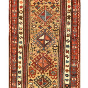 Long geometric runner with a beige field, blue and red diamond motifs, and detailed terracotta borders.