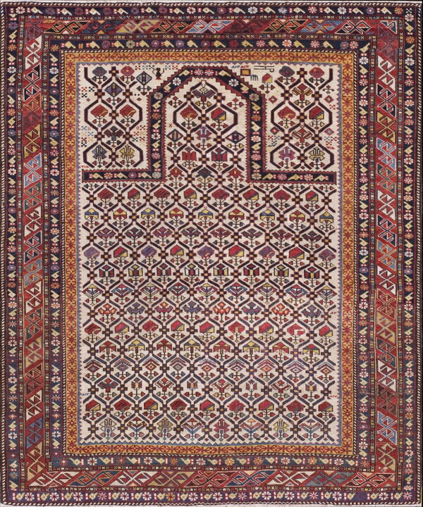 Low-pile rug featuring a cream field, deep red and navy geometric lattice design, and multi-banded borders.