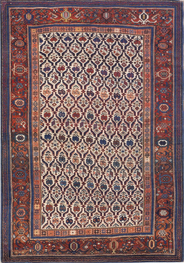 A patterned rug with a diamond navy and ivory field, framed by wide red and dark blue borders.