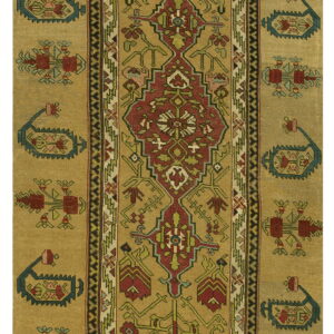 A gold runner rug featuring stylized geometric motifs in red, teal blue, and green.