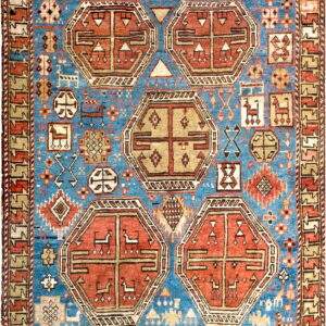 Blue, red, and beige rug displaying five large geometric medallions and small stylized animal motifs.