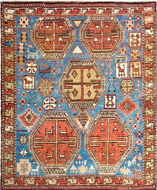 Blue, red, and beige rug displaying five large geometric medallions and small stylized animal motifs.