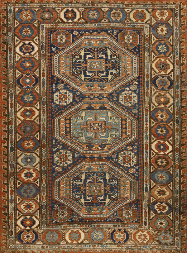 Intricate geometric rug displaying octagonal medallions, stylized animals, and wide borders in deep blue, rust, and cream.