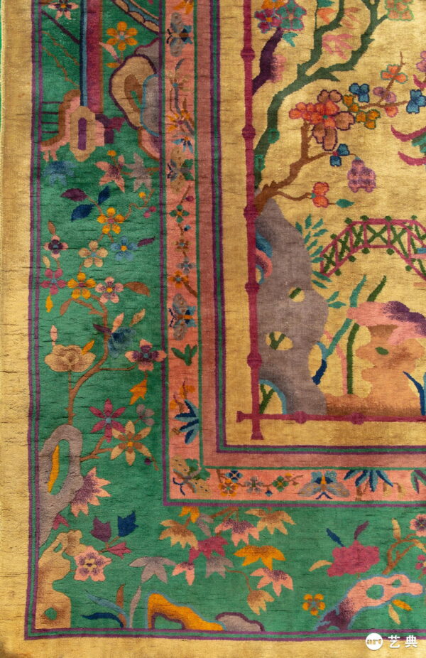 Detailed view of a gold and emerald green rug with multicolored botanical patterns and wide borders.