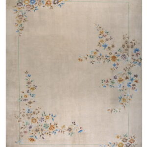 Light beige rug featuring colorful floral corner motifs and a thin pale green rectangular border.