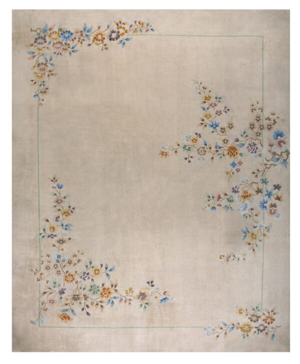 Light beige rug featuring colorful floral corner motifs and a thin pale green rectangular border.