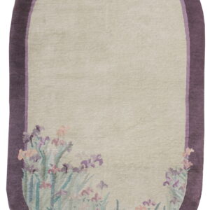 Oblong rug with a pale field, deep purple border, and stylized lavender iris flowers along the bottom edge.