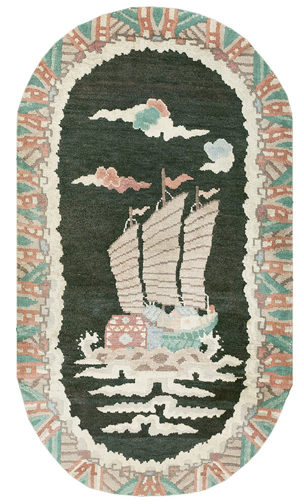 Oval dark green rug featuring a beige sailboat motif framed by an abstract rustic and mint green border.