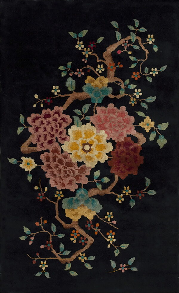 Black rug featuring a high-pile, colorful botanical design with pink, yellow, and teal flowering branches.