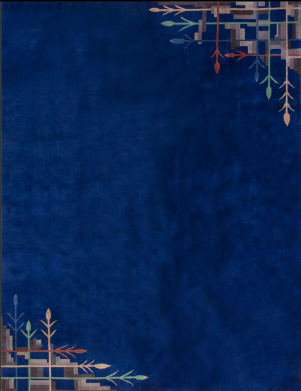 Navy blue rug featuring stylized geometric and arrowhead patterns in opposing corners.