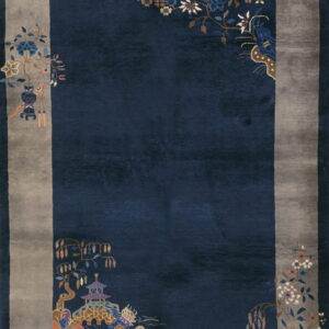 Plush dark blue rug with a gray border accented by multicolored stylized flowers and landscape scenes.