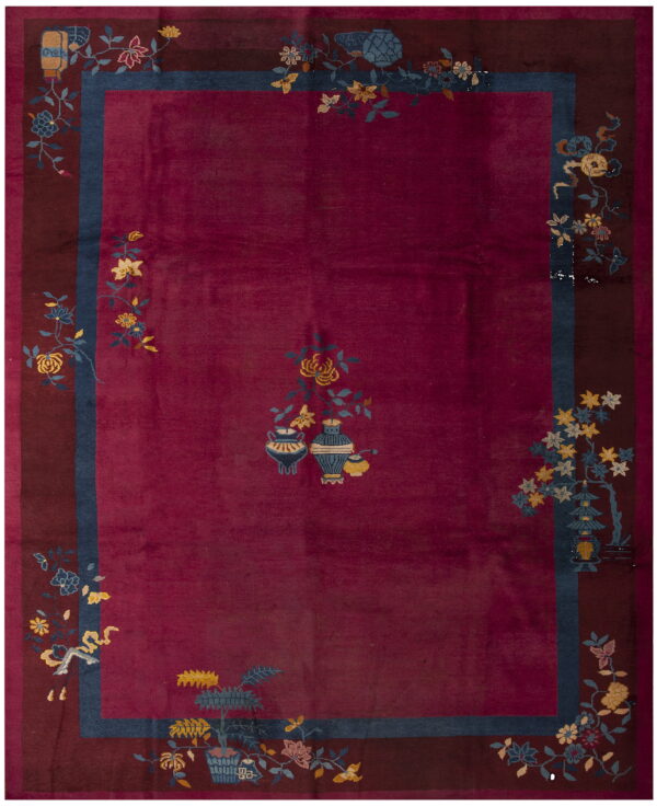 Deep magenta rug with a plush texture, maroon border, and scattered yellow and blue floral patterns.