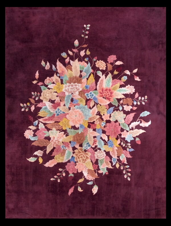 A deep plum rug centered with a vivid bouquet of pastel pink, blue, green, and yellow flowers.