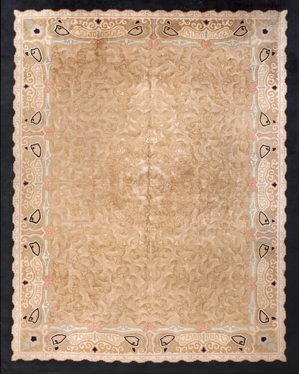 Distressed beige rug featuring a subtle field pattern and an ornate border with pink, black, and blue accents.