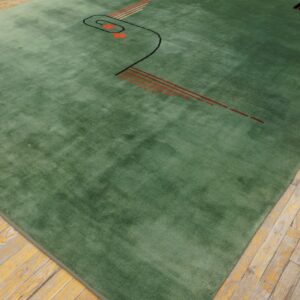 Green plush rug featuring abstract black and orange linear patterns on rustic hardwood floors.