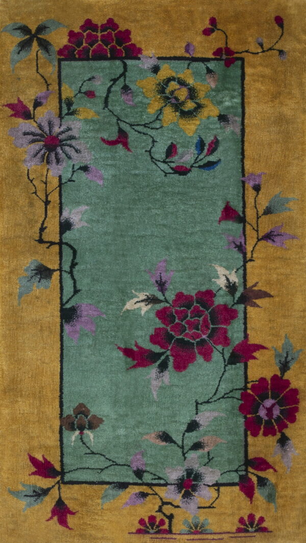 Gold border rug with a teal panel featuring large magenta, purple, and yellow floral designs.