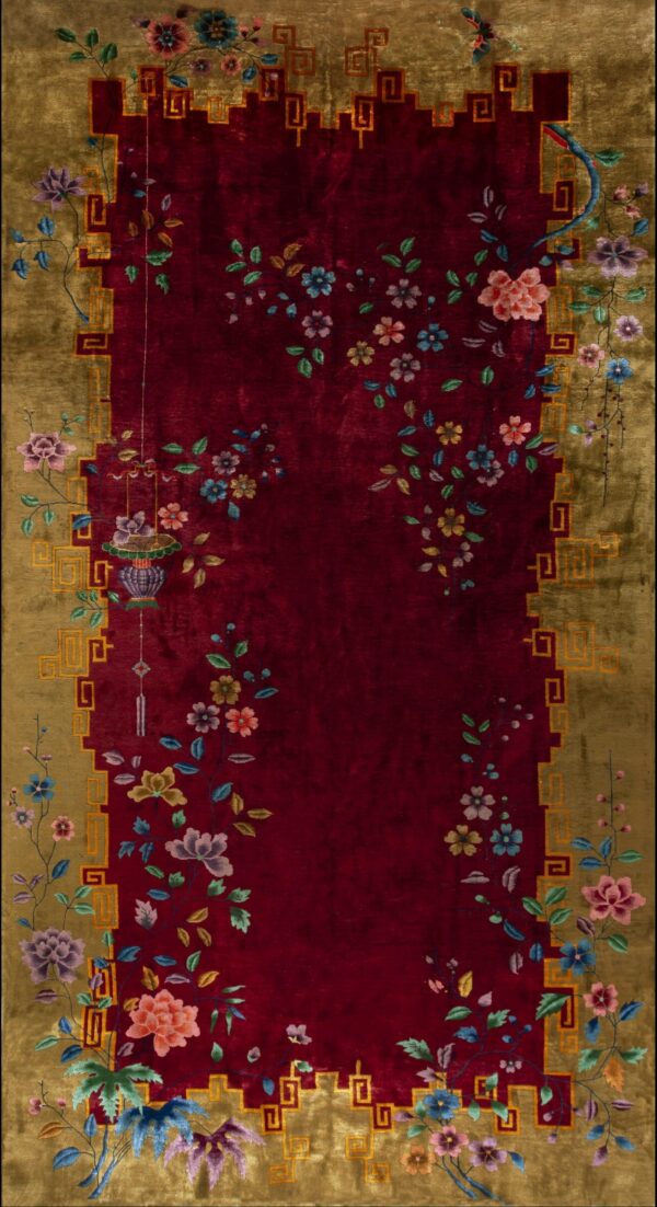 Traditional rug with a red center, gold border, and sprawling colorful floral and lantern motifs.