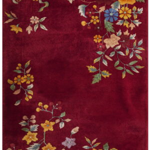 High-pile red rug with dense multicolor floral clusters along the perimeter.