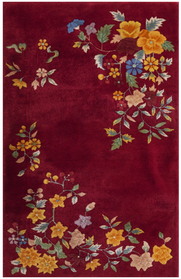 High-pile red rug with dense multicolor floral clusters along the perimeter.