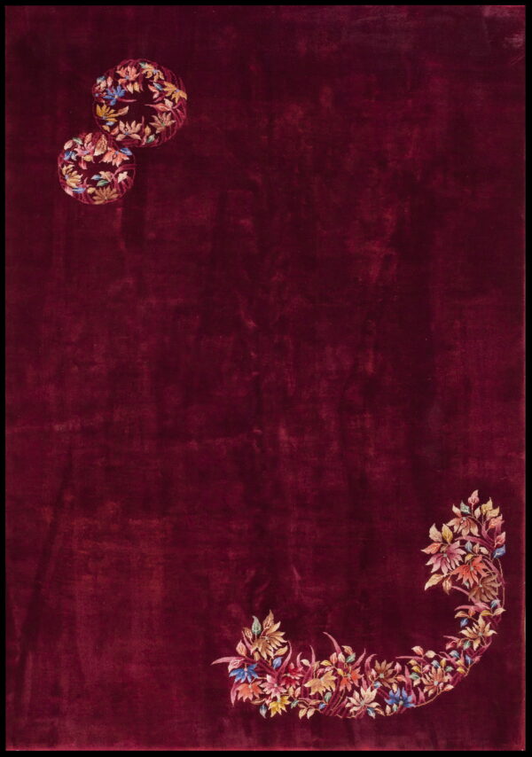 Solid maroon rug with colorful floral arrangements in the upper left and lower right corners.