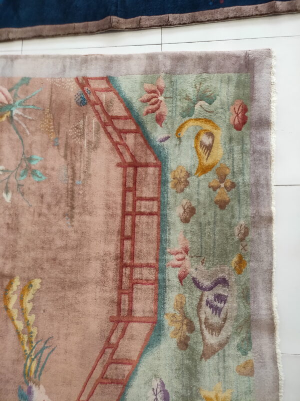 Red knotted antique 1920s room size wool rectangle chinese - art deco rug 8 High-pile pictorial rug featuring botanical and trellis patterns in muted pink, sage, and gold on white tile.