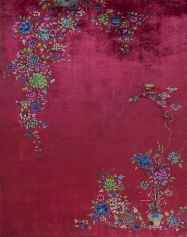 Plush, high-pile magenta rug featuring scattered blue, green, and pink botanical floral corner motifs.