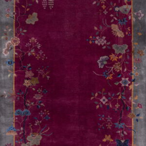 Deep magenta rug featuring a gray border and vibrant floral vines bordering the central field.