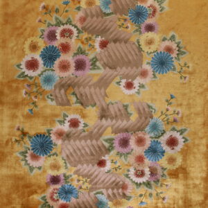 Shiny, plush golden rug featuring large multicolored flowers and a zig-zagging brown segmented pattern.