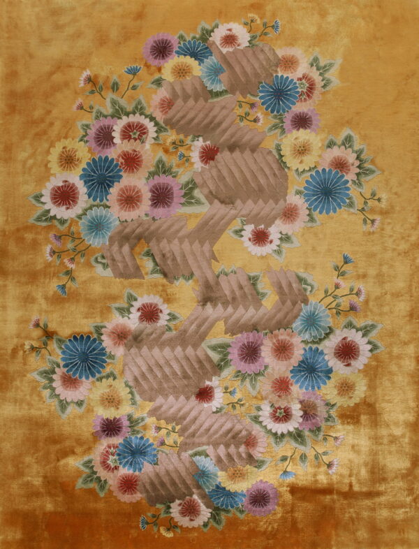 Shiny, plush golden rug featuring large multicolored flowers and a zig-zagging brown segmented pattern.