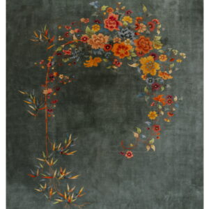 Dark green rug with a sweeping botanical pattern of vibrant orange, yellow, and multicolored flowers.