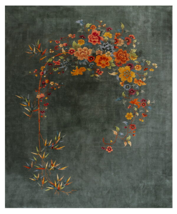 Dark green rug with a sweeping botanical pattern of vibrant orange, yellow, and multicolored flowers.