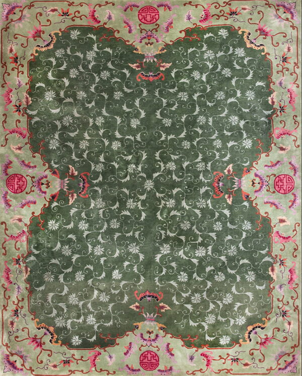 High-pile green rug featuring light green all-over floral pattern and a pale border with pink and red accents.
