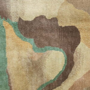 Textured, mid-pile rug detail showing wavy abstract shapes in brown, tan, and seafoam green colors.