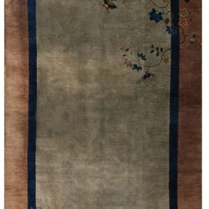 Muted sage rug with a lustrous low pile, brown border, and navy accents framing delicate floral vines.