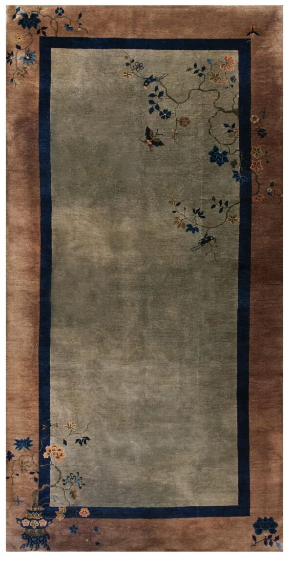 Muted sage rug with a lustrous low pile, brown border, and navy accents framing delicate floral vines.