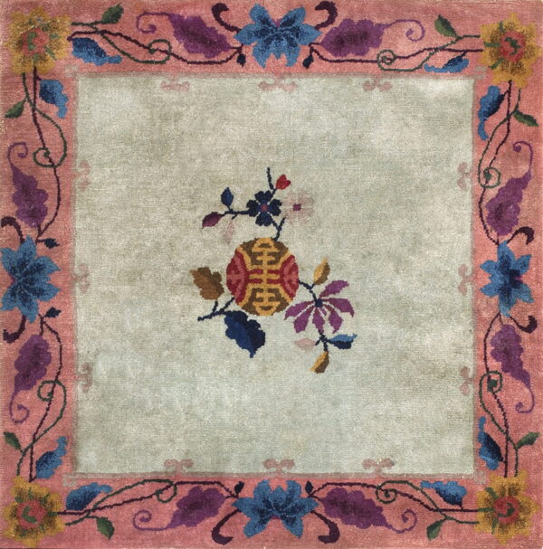 Square rug with a pale green field and a rose border featuring blue, purple, and yellow floral designs.
